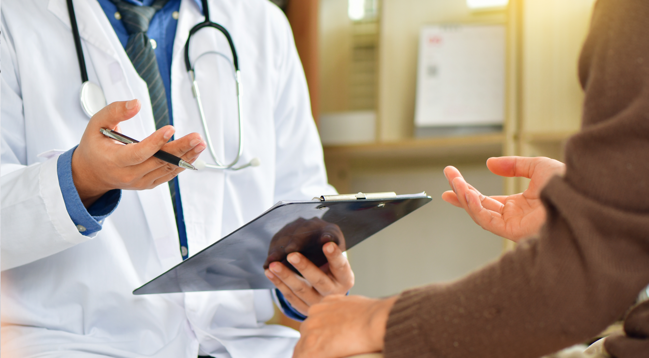 Lekarz trzyma dokumenty i rozmawia z pacjentem